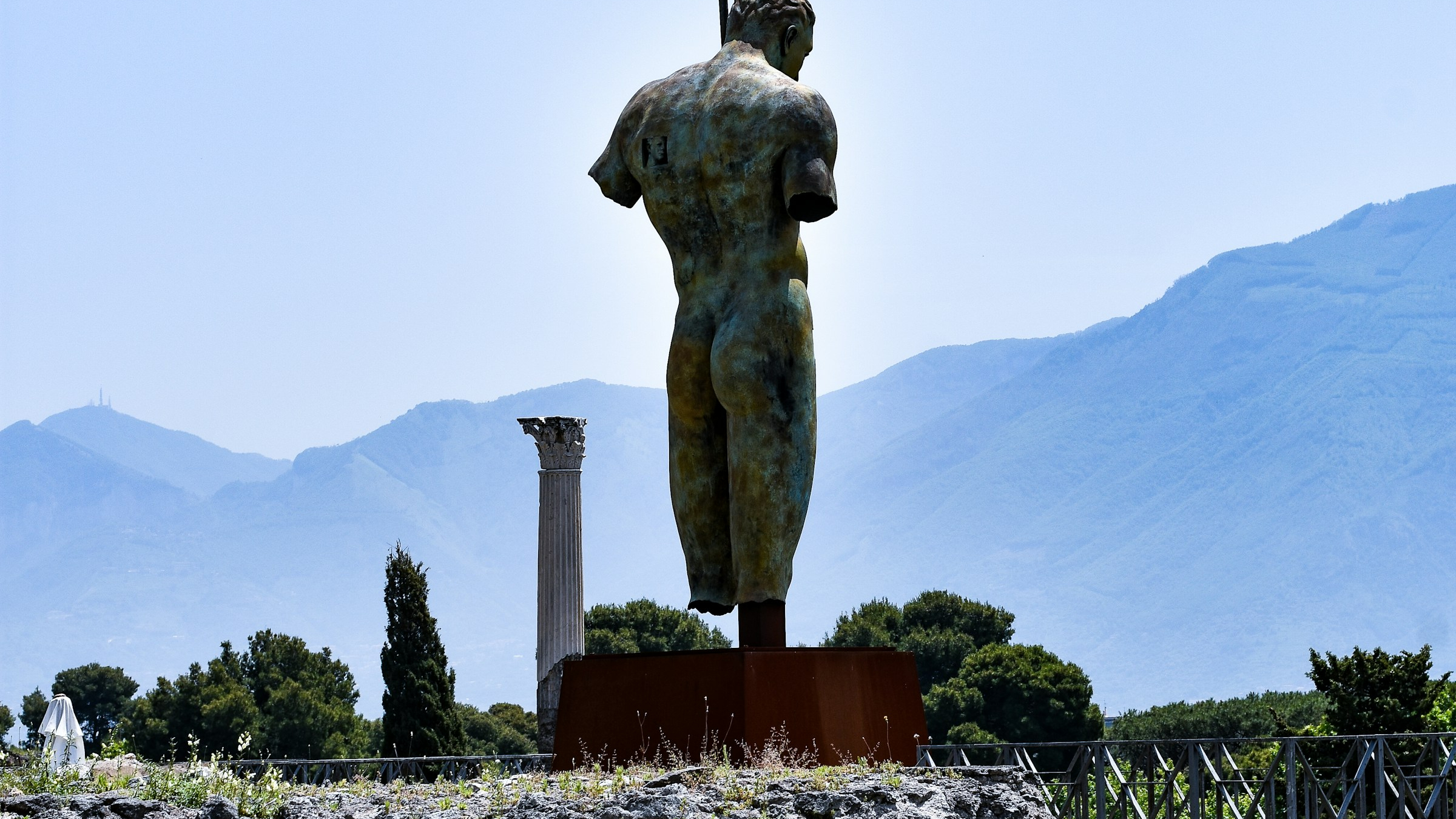 remains of a statue at pompeii of a muscular male torso