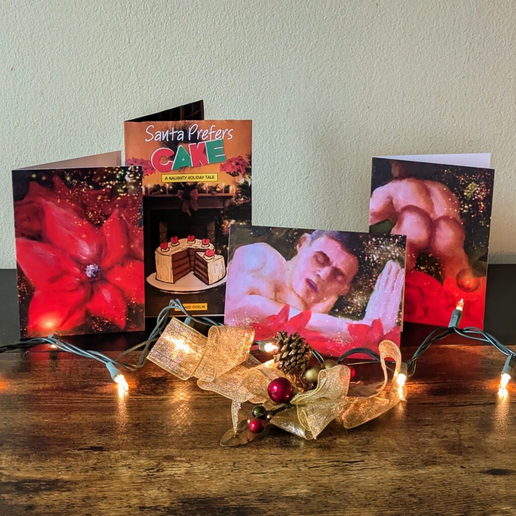 three holiday cards and a Christmas themed mini comic displayed on a table with Christas decorations